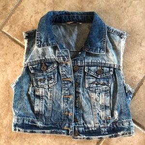 Distressed sleeveless denim jacket